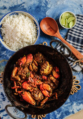 Spicy Crab Curry, Steamed White Rice, and Lemon Wedges