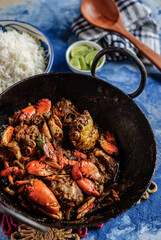 Spicy Crab Curry, Steamed White Rice, and Lemon Wedges