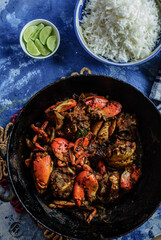 Spicy Crab Curry, Steamed White Rice, and Lemon Wedges