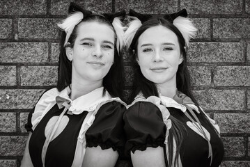 Grayscale portrait of two cosplay girls dressed as Japanese Maids