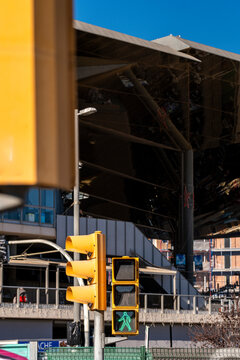 Yellow traffic light at an intersection in the middle of a cityscape in a modern financial area