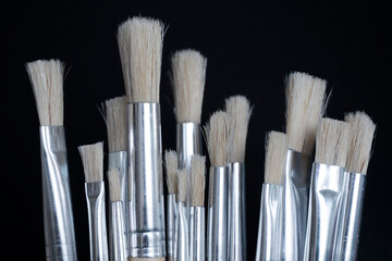 Paint brushes isolated on black background