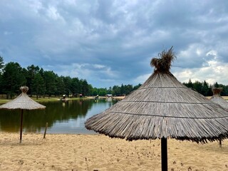 A beach by a reservoir in the forest.