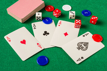 top view of cards and dice on green playing mat, horizontal, with copy space