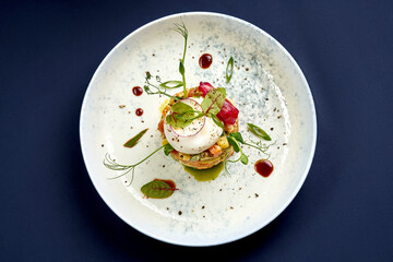 Salad with mayonnaise, chicken, peas, carrots and poached egg. A modern take on Ukrainian salad Olivier