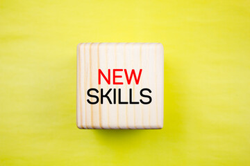 NEW SKILLS, inscription, text on a wooden cube. New Skills concept.