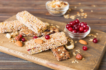 Various granola bars on table background. Cereal granola bars. Superfood breakfast bars with oats, nuts and berries, close up. Superfood concept