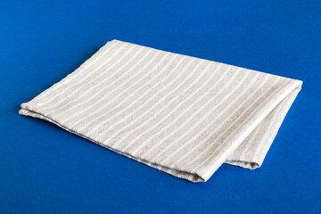 top view with gray kitchen napkin isolated on table background. Folded cloth for mockup with copy space, Flat lay. Minimal style