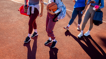Naklejka premium Close up of female legs walking on basketball court.