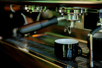 Close-up of espresso pouring from coffee machine - stock photo