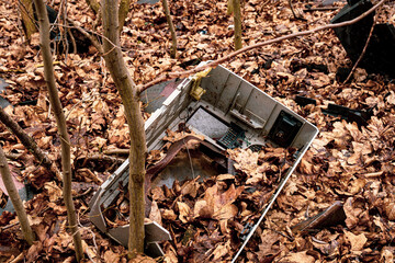 Broken Cathode Electron Beam Tube of Old TV, shattered television trash in the woods, littering in the forest, illegal landfill, forest pollution