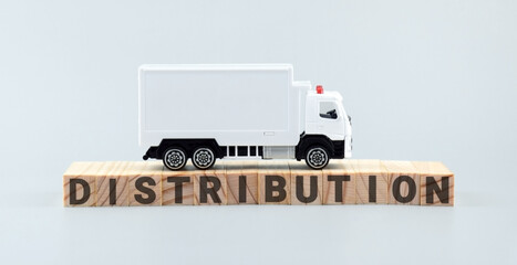 White toy truck on blocks with the text DISTRIBUTION.