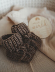 Knitted slippers and things for a newborn in the cradle