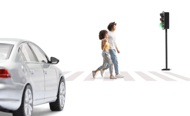 Boyfriend and girlfriend in embrace walking at a pedestrian crossing in front of a car