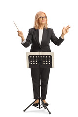 Female conductor behind a music note stand