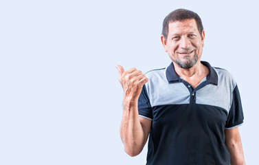 Fototapeta premium Smiling senior man pointing at a banner to the side. Senior old man pointing at promotion isolated