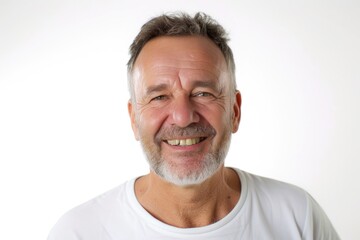 Obraz premium A man wearing a white shirt smiles at the camera. Suitable for various uses