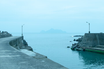 Cloudy day in Dali fish harbor with light blue ocean and Guishan Island in the front
