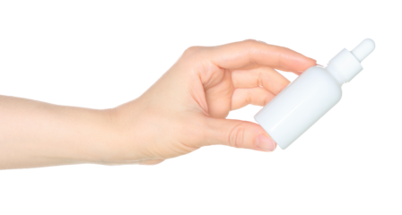 Woman hand holds a white cosmetic bottle, isolated on white background close-up, template for cosmetics ads