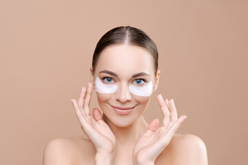 Eye patch. Beauty woman face with under eye collagen pads. Studio shot of young woman has fresh...