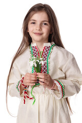 Bulgarian girl with snowdrops spring flowers bouquet wearing traditional ethnic folklore dress and white red yarn bracelet martenitsa martisor, Bulgaria - 728414342