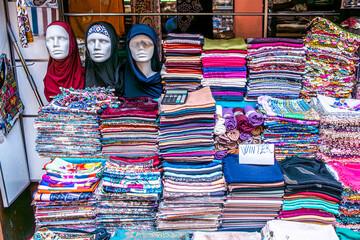 An array of miscellaneous clothes in the Grand Bazaar, a vibrant and diverse display of traditional textiles, eclectic patterns, and unique garments.