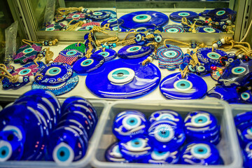 An abundance of evil eyes in the bazaar, vibrant talismans of Turkish cultural heritage, displayed...