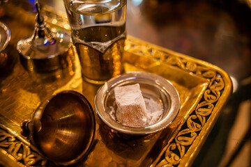 Indulge in the delightful pairing of Turkish delight and a refreshing glass of water, capturing the...
