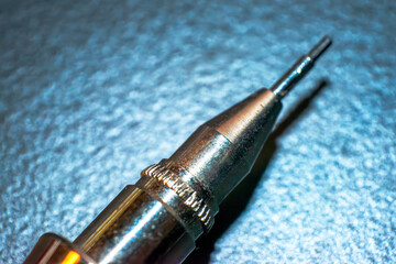 The fine tip of an engineering pencil, a precise tool for drafting, drawing, and expressing...