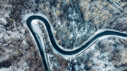 Aerial view of winding mountain road in winter.