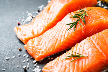 Salmon fillet, raw fresh fish with rosemary and spices. Macro image.