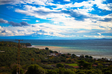 A serene coastal town, where charming houses line the beach and a peaceful harbor welcomes the sea breeze, creating an idyllic scene by the water