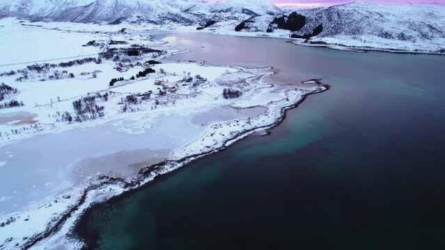 Lofoten establishing Winter dynamic aerial tilt up near Sortland