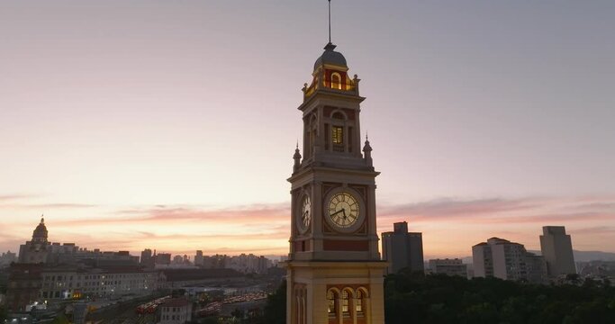 Aerial tilt down of Luz Station clock tower at sunset, Sao Paulo, Brazil