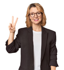 Caucasian woman in black business suit joyful and carefree showing a peace symbol with fingers.