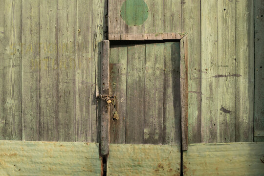 Background old green wooden barn door and façade