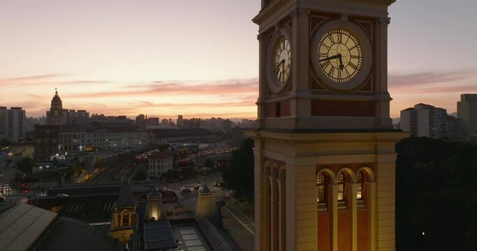 Sunset in Sao Paulo. Luz Station clock tower illuminated in foreground. Aerial
