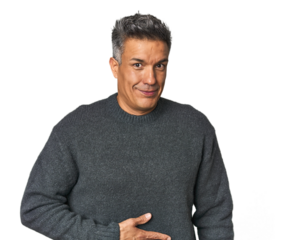 Middle-aged Latino man touches tummy, smiles gently, eating and satisfaction concept.