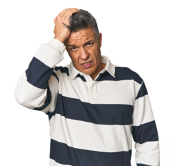 Middle-aged Latino man tired and very sleepy keeping hand on head.