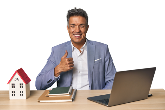 Middle-aged Hispanic businessman with real estate theme smiling and raising thumb up - Powered by Adobe