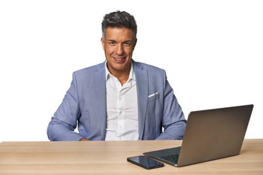 Elegant businessman at desk with laptop confident keeping hands on hips.