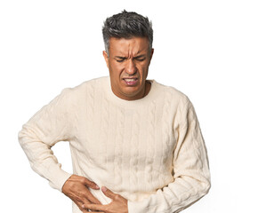 Middle-aged Latino man having a liver pain, stomach ache.