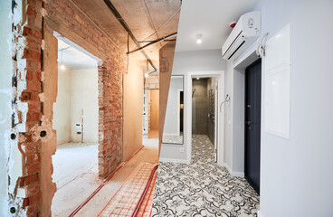Old apartment with brick walls and new renovated flat with doors, mirror, air conditioner and...