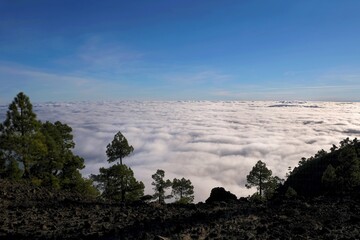 Beautiful mountain view with inversion phenomenon and low clouds lit by sun. During trekking from...