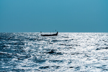 Boat floating on the sea no men zone, beautiful mist at Alleppey beach Kerala 