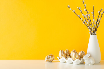 Easter countertop theme. Side view of a counter with a porcelain container holding gilded eggs,...