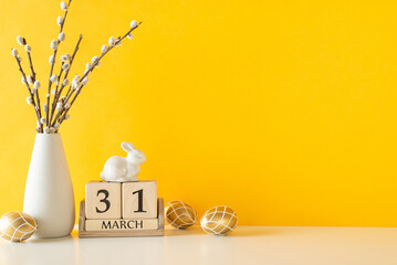 Modern Easter kitchen design. Close-up side view of a table featuring shimmering golden eggs, a...