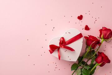 Prime woman's holiday design. Top-down view capturing an extravagant assembly of roses, voguish heart box, décor, and confetti over a pale pink setting, space allotted for text or advertising