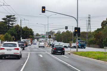 Stopping at orange lights at intersection in city