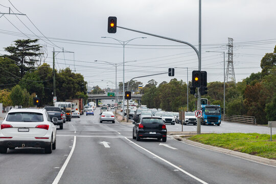 Stopping at orange lights at intersection in city